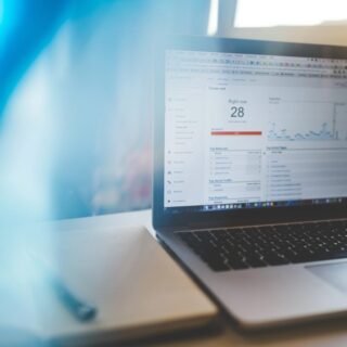 Seseorang sedang mempelajari grafik pertumbuhan pengunjung dan data demografi pada dasbor Google Analytics 4.